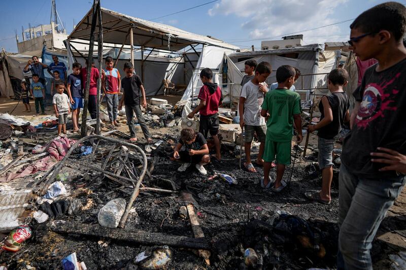 Palestinians inspect the damage at a tent area in the courtyard of Al Aqsa Martyrs hospital (Abdel Kareem Hana/AP)