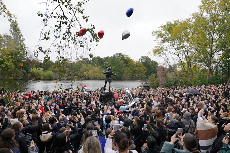 People release balloons during a vigil for Payne at Hyde Park in central London