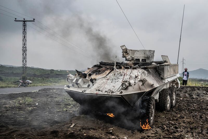 A UN armoured personnel carrier burns during clashes with M23 rebels outside of Goma, (Moses Sawasawa/AP)