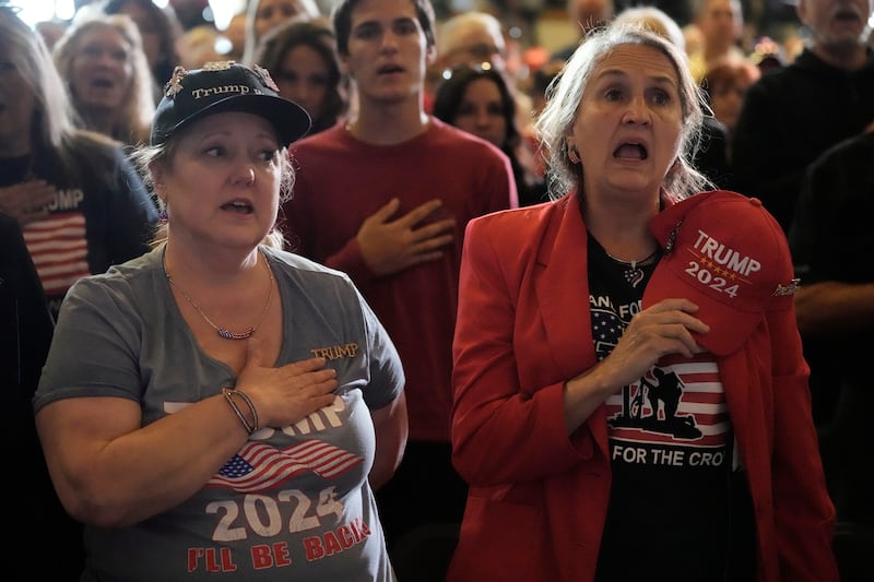 Supporters stand for the National Anthem before Republican presidential candidate former President Donald Trump appears at a campaign rally in Waukesha, Wisconsin (Morry Gash/AP)