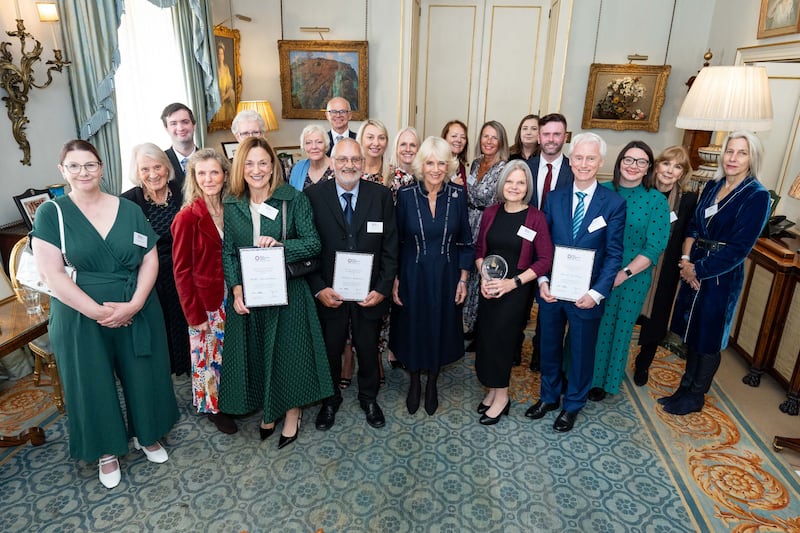 Queen Camilla poses with award winners and guests during the reception. Aaron Chown/PA