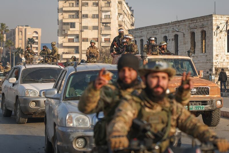 A convoy of insurgents in civilian vehicles arrives in Hama (Ghaith Alsayed/AP)