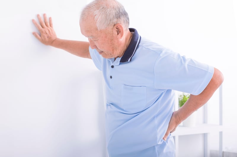 Senior man experiencing lower back pain