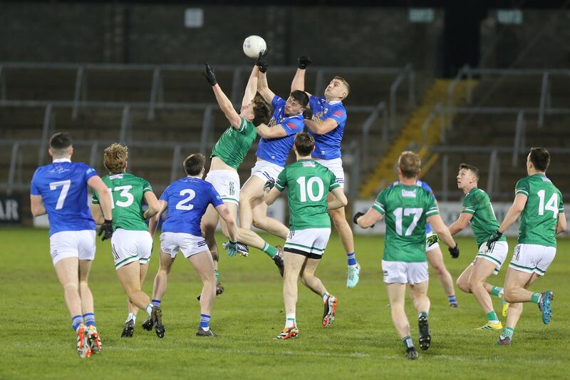 Joe McDade, James Smith and Killian Clarke contest the kickout as players from both sides await the outcome. Photo: Adrian Donohoe.