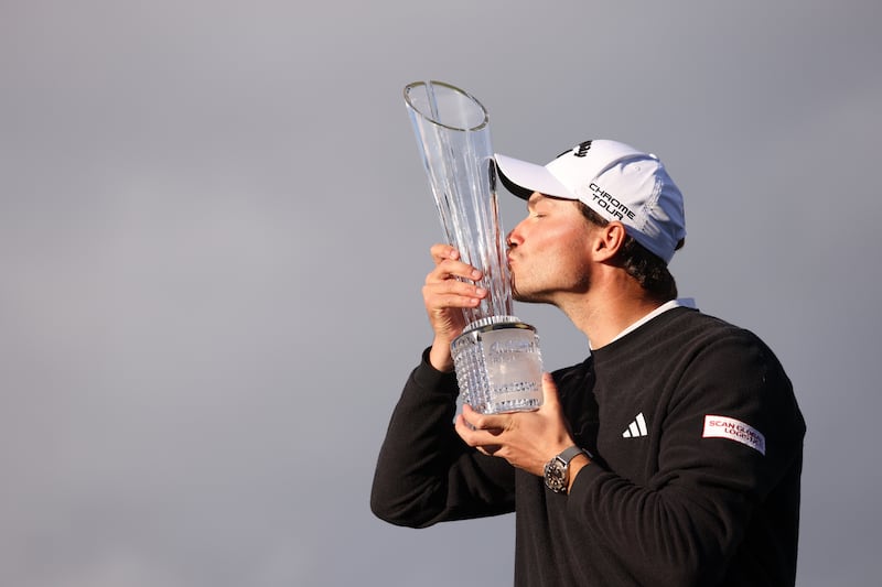 Denmark's Rasmus Hojgaard kisses the trophy after winning the Amgen Irish Open 2024 at Royal County Down in Newcastle on Sunday. Picture by PA