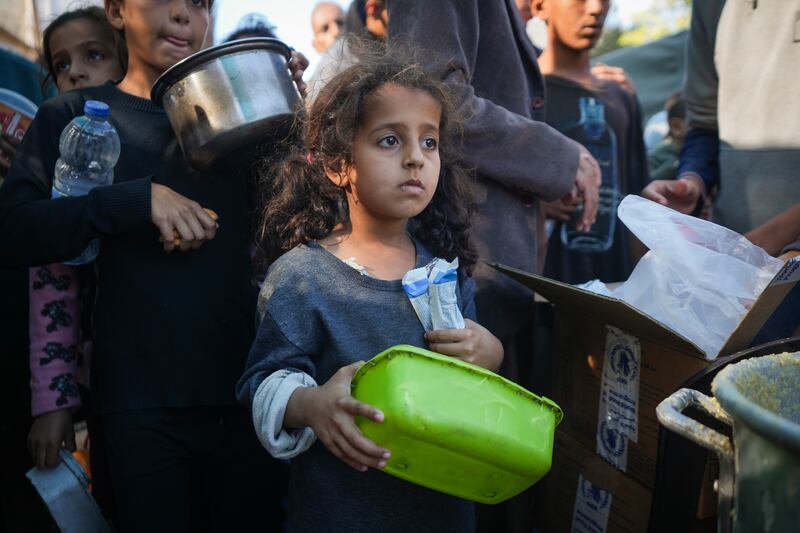 A Palestinian girl queues for food in Deir al-Balah, Gaza Strip (Abdel Kareem Hana/AP)