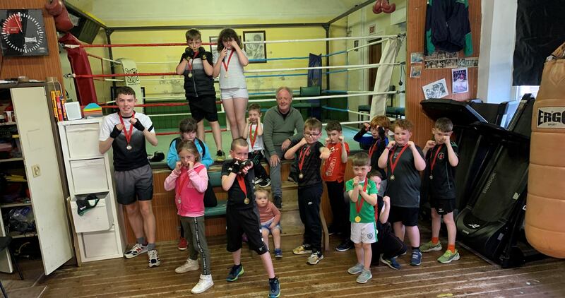 Hugh Russell with young boxers. Olympic boxers are Irish legends