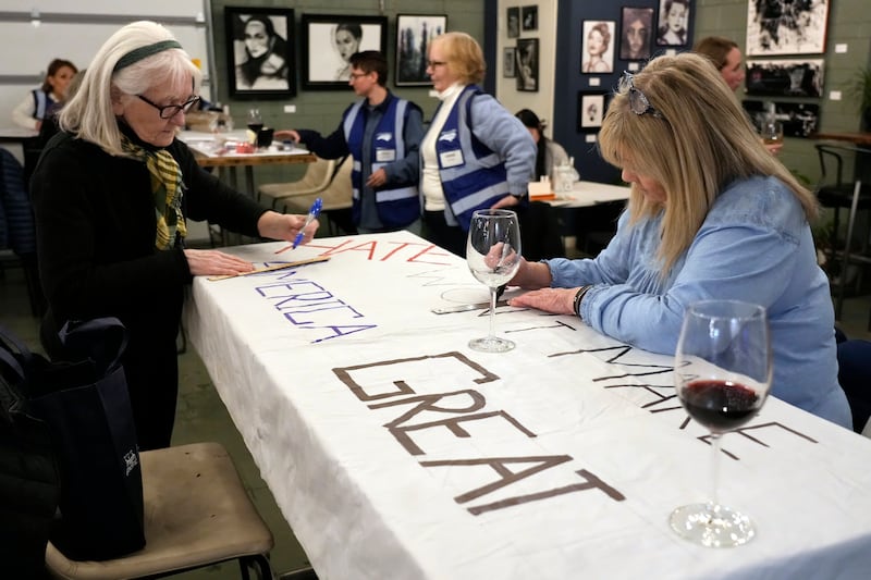 Ann Kourelis, left, and Candee Minchin, right, work on a protest sign (Chuck Burton/AP)