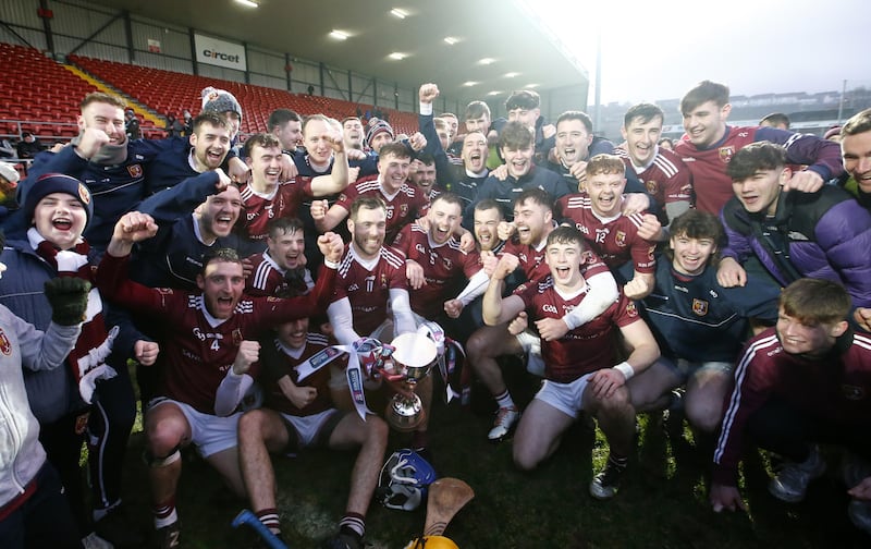 The Cushendall players celebrate with the Four Seasons Cup after Sunday's Ulster final win over Slaughtneil