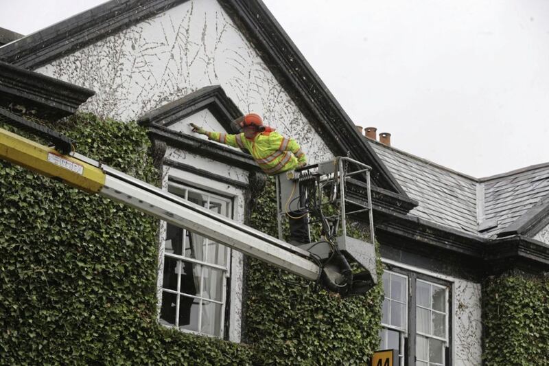 The ivy being cut back on the Londonderry Arms Hotel in Carnlough. Picture by Hugh Russell 