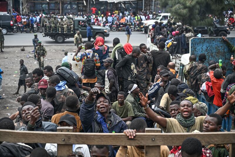 M23 rebels escort government soldiers and police who surrendered to an undisclosed location in Goma (Moses Sawasawa/AP)