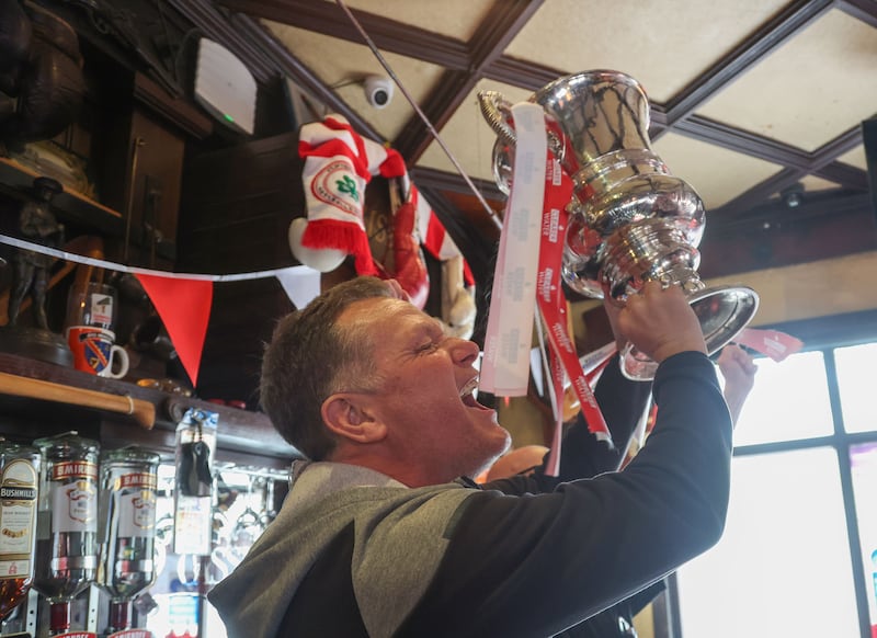 Cliftonville celebrate with the fans during an open top bus tour across Belfast after winning the Irish Cup oat Windsor on Saturday.
PIC COLM LENAGHAN