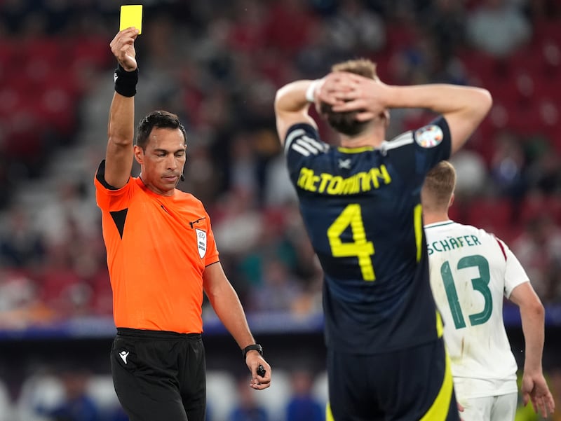Scotland midfielder Scott McTominay is shown a yellow card during his team’s defeat to Hungary