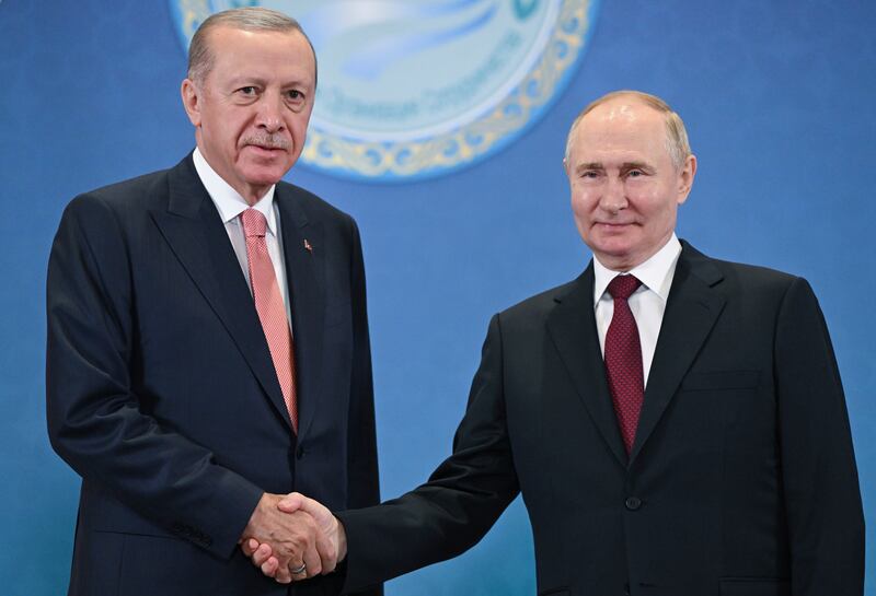 Russian President Vladimir Putin, right, and Turkey’s President Recep Tayyip Erdogan shake hands as they pose for photos (Sergey Guneyev, Sputnik, Kremlin Pool Photo via AP)