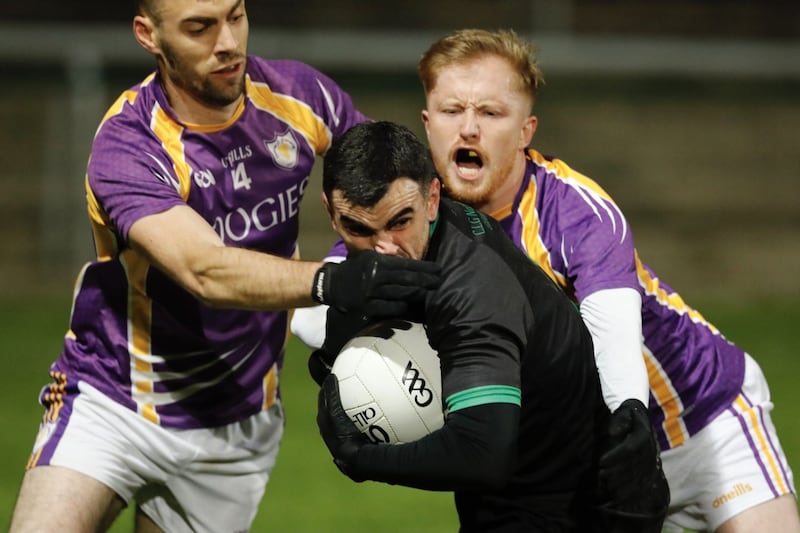 Ederney's Chris Snow for Ederney is tackled by Derrygonnelly's Conall Jones and Leigh Jones during Friday night's Fermanagh SFC quarter-final               Picture: Donnie Phair&nbsp;