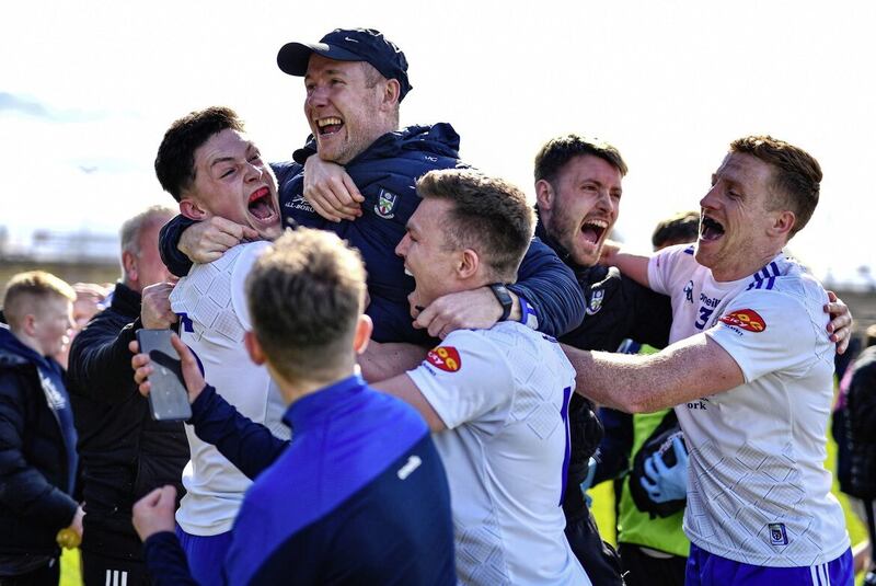 Monaghan players celebrate with manager Vinny Corey after surviving in Division One in March. Picture by Sportsfile