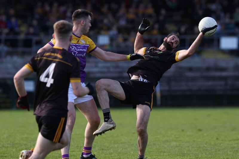 Derrygonnelly midfielder Ryan Jones competes for the ball with Brian Mullin of Erne Gaels.