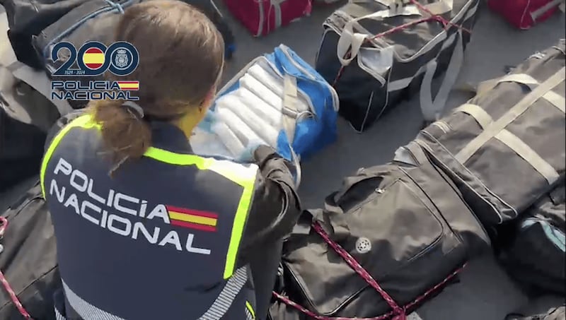 Officer from Spanish Policía Nacional inspects a drugs shipment .