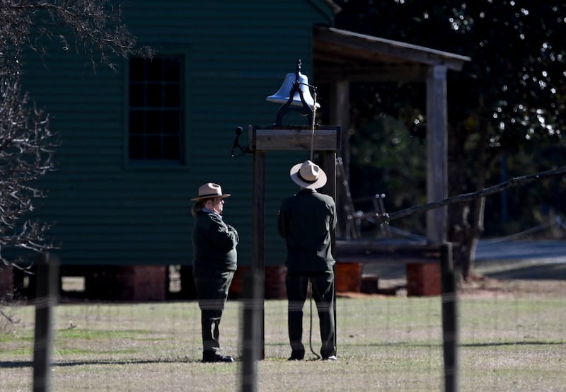 Karen Barry, left, and Randy Dillard ring the farm bell 39 times (Hyosub Shin/Atlanta Journal-Constitution/AP)