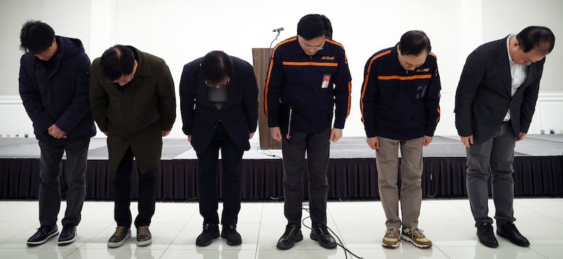 Jeju Air chief executive Kim E-bae, fourth from left, and other executives bow in apology ahead of a briefing in Seoul, South Korea (Im Hun-jung/Yonhap/AP)