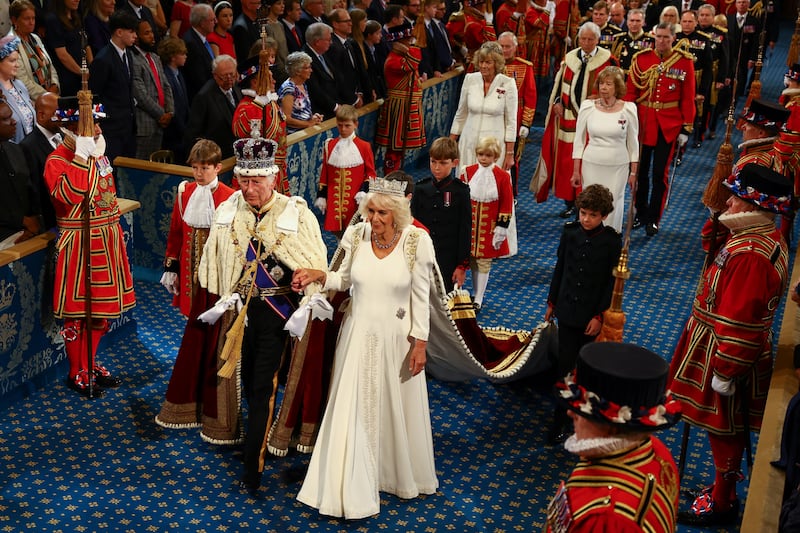 The King, wearing the Imperial State Crown and the Robe of State, and Queen, wearing the George IV State Diadem, leave after the State Opening of Parliament