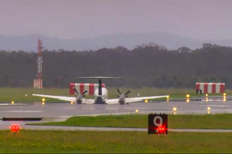 In this image taken from video, a light plane lands safely without landing gear at Newcastle Airport, Australia (Channel 10 via AP)