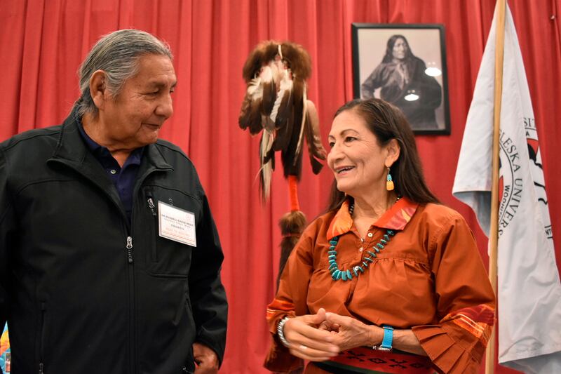 Russell Eagle Bear, with the Rosebud Sioux Reservation Tribal Council, speaks to Deb Haaland during a meeting about Native American boarding schools at Sinte Gleska University (Matthew Brown/AP)