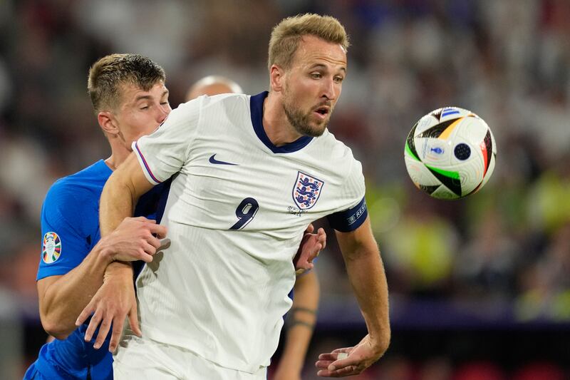 England’s Harry Kane challenges for the ball with Slovenia’s Jaka Bijol during the Euro 2024 game. (Andreea Alexandru/AP)