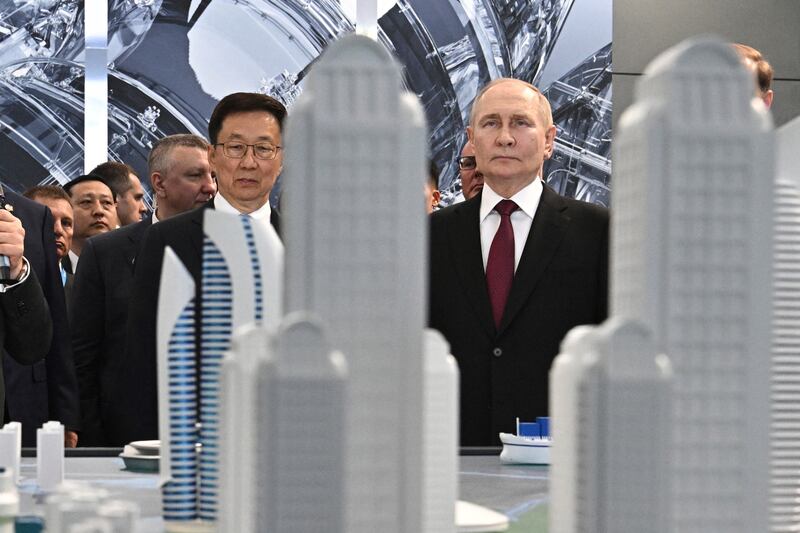 Vladimir Putin, right, and Chinese Vice President Han Zheng, left, visit the Russian-Chinese EXPO in Harbin, in northeastern China’s Heilongjiang Province, on Friday (Sergei Bobylev, Sputnik, Kremlin Pool Photo via AP)