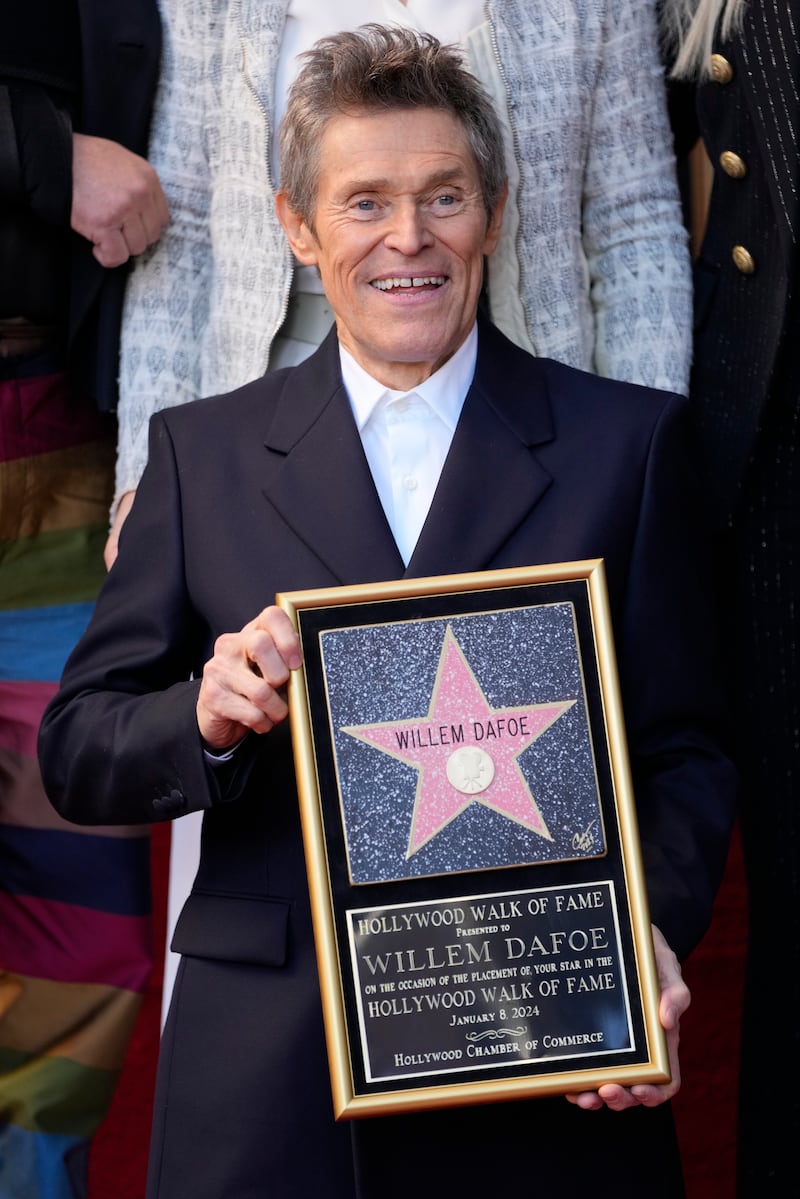 Willem Dafoe holds a plaque at a ceremony honouring him with a star on the Hollywood Walk of Fame (Chris Pizzello/AP)