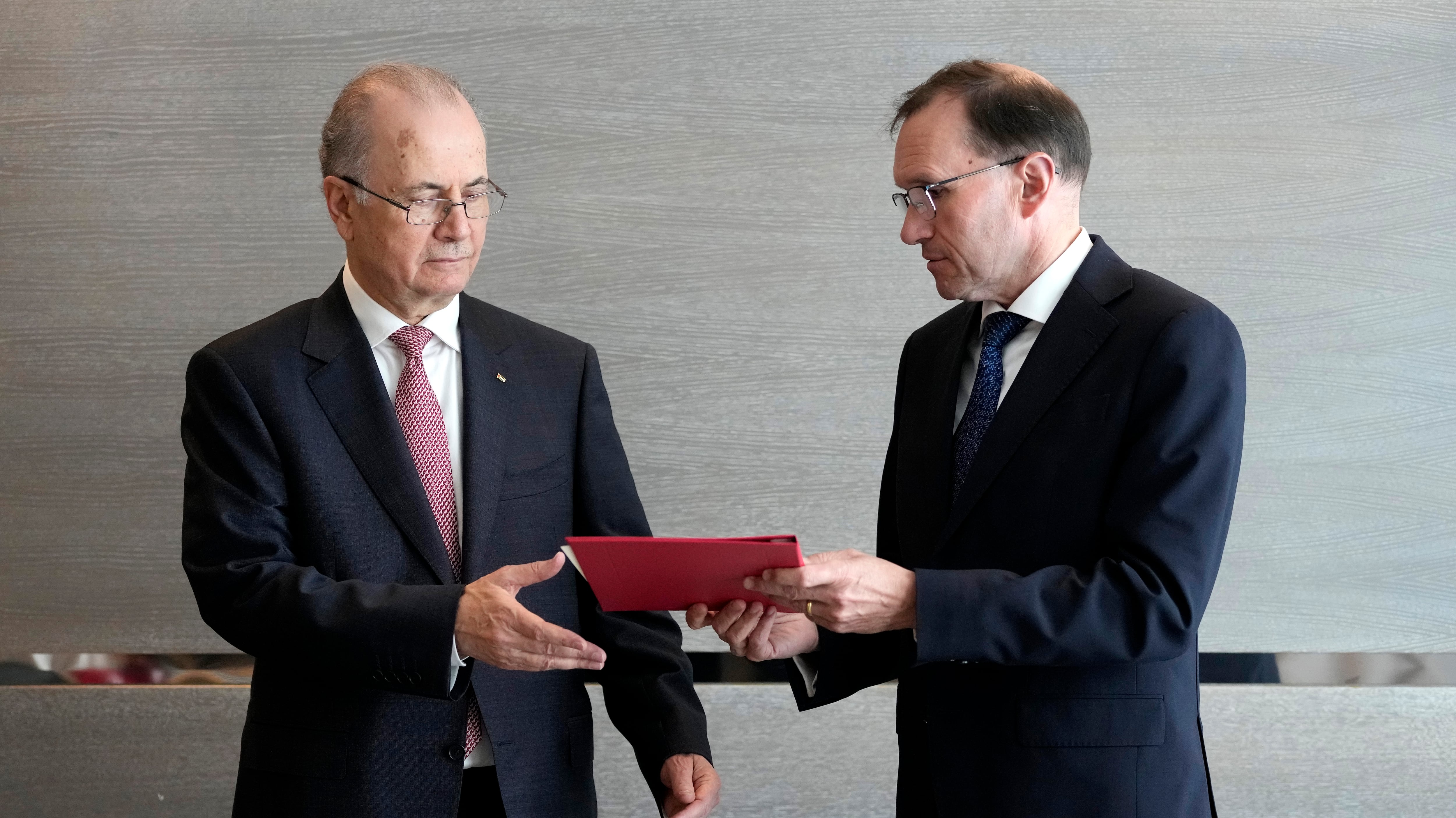 Norway’s foreign minister Espen Barth Eide, right, hands a document to prime minister of the Palestinian Authority, Mohammed Mustafa (Virginia Mayo/AP)