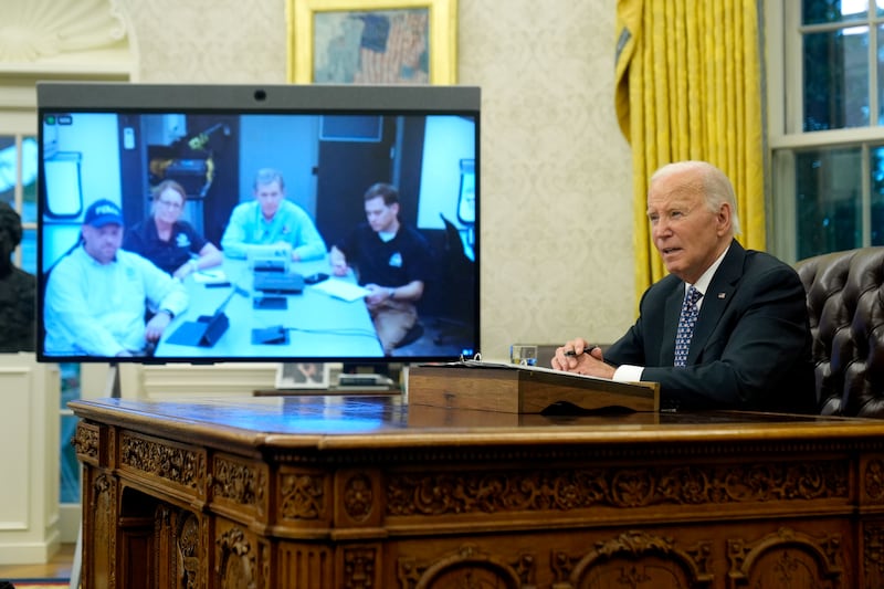 Joe Biden, right, speaks with North Carolina governor Roy Cooper by videolink (Mark Schiefelbein/AP)