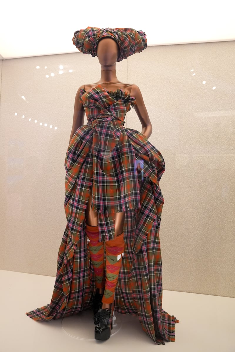 A tartan dress worn by Naomi Campbell during Vivienne Westwood’s Fall 1994 Ready-to-Wear fashion show is on display at the exhibition