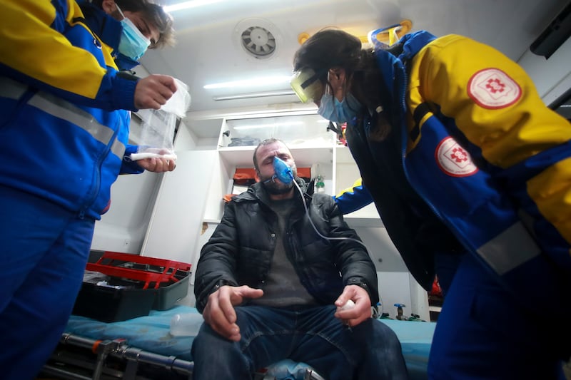 Paramedics treat a protester after clashes with police (Zurab Tsertsvadze/AP)