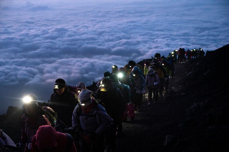 A group of hikers climb to the top of Mount Fuji (Jae C Hong/AP)