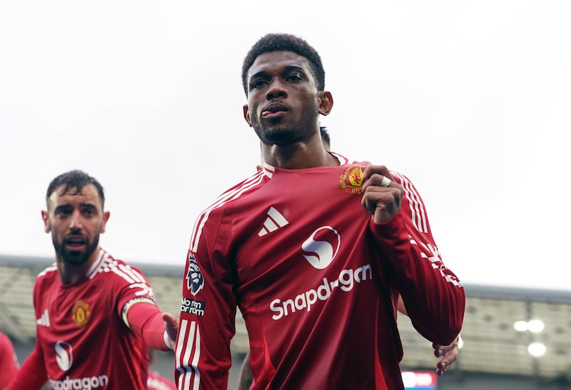 Manchester United’s Amad Diallo (right) celebrates scoring their side’s first goal of the game during the Premier League match at the American Express Stadium