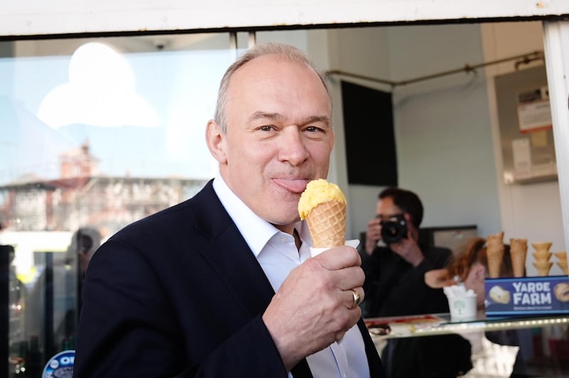 Sir Ed Davey eats ice cream on the promenade in Eastbourne while on the General Election campaign trail