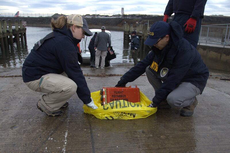 Investigators examine a flight data recorder recovered from the Potomac (NTSB/AP)