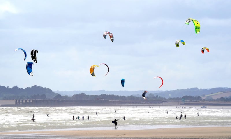 Kite surfers enjoy the windy weather at Camber Sands, East Sussex (Gareth Fuller/PA)