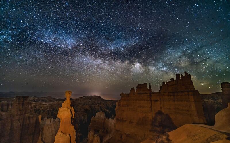 The Milky Way low in the sky over Thor’s Hammer below Sunset Point in Bryce Canyon National Park, Utah