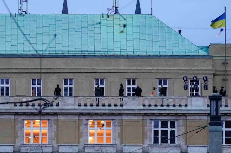 Police officers stand on the balcony of the philosophical faculty of Charles University (Petr David Josek/AP)