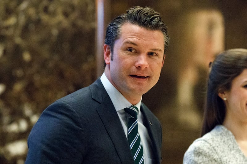 Pete Hegseth walks to an elevator for a meeting with President-elect Donald Trump at Trump Tower (Evan Vucci/AP)