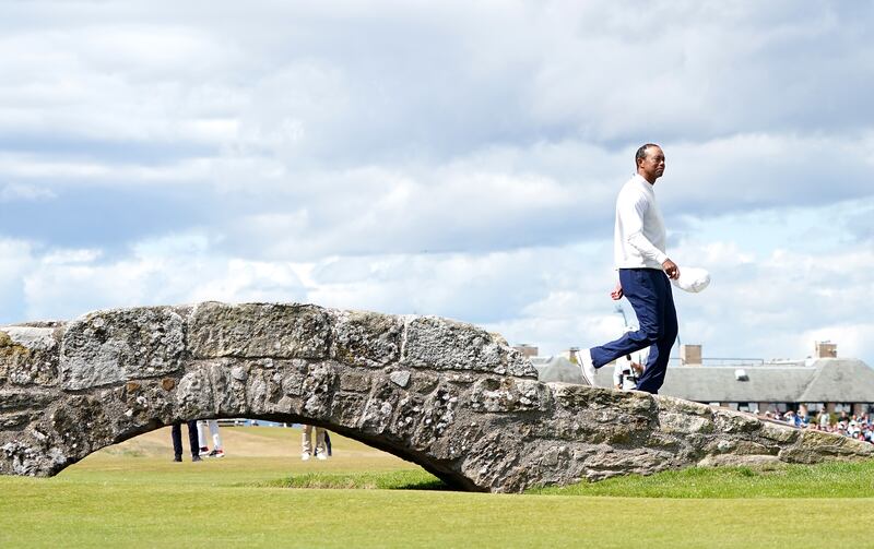 Tiger Woods waves to the crowd as he goes over the Swilcan Bridge on the 18th during day two of The Open at the Old Course, St Andrews