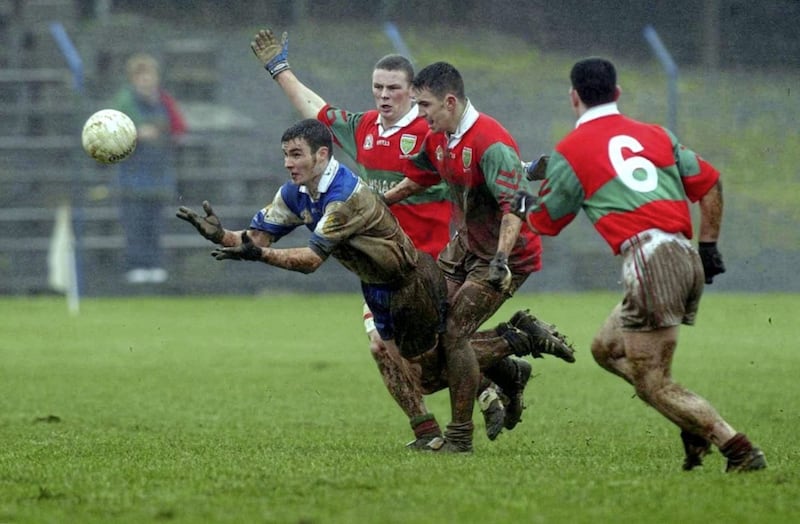 Where there&#39;s muck there&#39;s brass... Declan Bateson of Ballinderry first to the ball ahead of Eamon Franey, Mark Coffey and Trevor Doyle of Rathnew, during the AIB All-Ireland Senior Club Football Championship semi-final at Pearse Park in Longford in 2002. Photo by David Maher/Sportsfile 