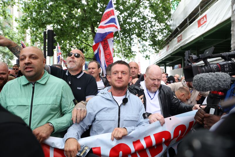 Tommy Robinson (centre) leads a protest march through London in June