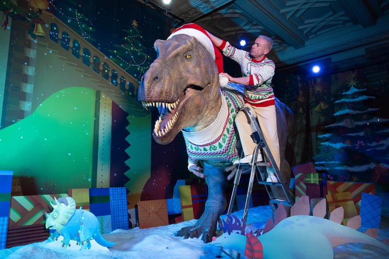 The T. rex has donned its Christmas knitwear amidst a winter scene