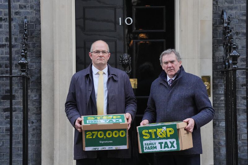 NFU president Tom Bradshaw, left, and NFU Cymru president Aled Jones handing in a petition at 10 Downing Street