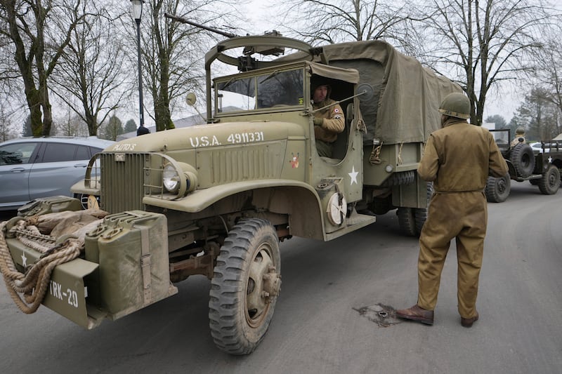 Living history enthusiasts drive their vintage vehicles during the 80th commemoration of the Battle of the Bulge in Bastogne, Belgium (Virginia Mayo/AP)