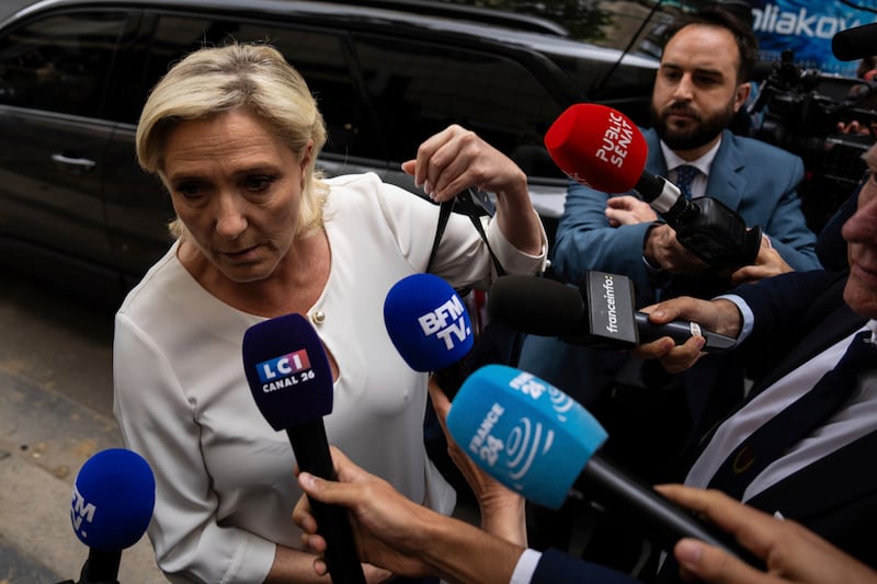 Marine Le Pen, leader the French far-right, arrives at the National Rally party headquarters on Monday (Louise Delmotte/AP)