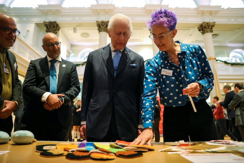 Charles is shown items used in humanitarian responses by paediatric nurse Becky Platt during a visit to St Peter’s Church in Notting Hill